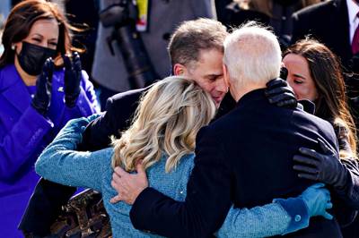 US President Joe Biden, right, is embraced by his son, Hunter Biden, and First Lady Jill Biden after being sworn in during his inauguration on January 20. EPA