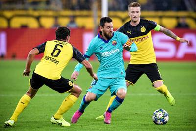 Barcelona's Lionel Messi in action against Dortmund's Thomas Delaney and Marco Reus. EPA