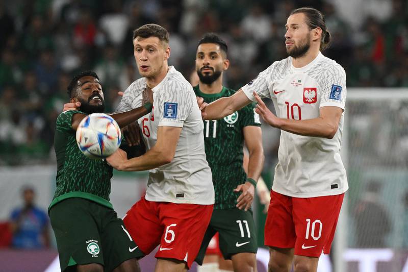 Saudi Arabia's midfielder Nawaf Al-Abed fights for the ball with Poland's Krystian Bielik. AFP