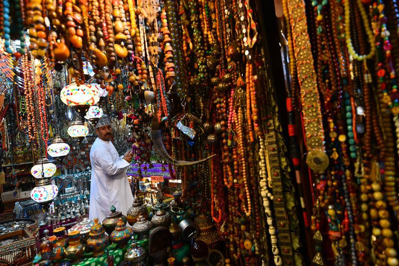 A man stands at a souvenir shop on November 26, 2018 in the Omani capital Muscat. (Photo by GIUSEPPE CACACE / AFP)