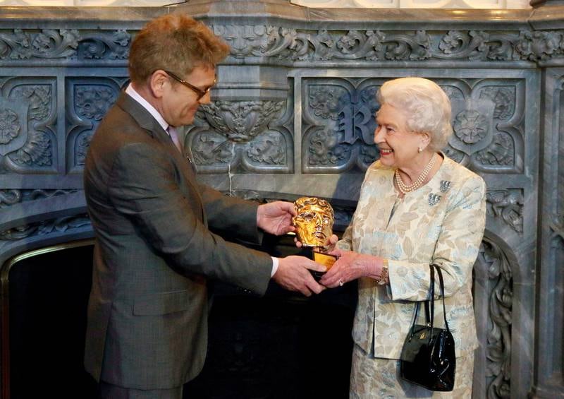 Queen Elizabeth receives an honorary Bafta from actor Kenneth Branagh at Windsor Castle. Getty