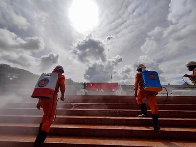 Firefighters spray disinfectant to curb the spread of coronavirus at the Martyrs' mausoleum in Yangon, Myanmar. EPA