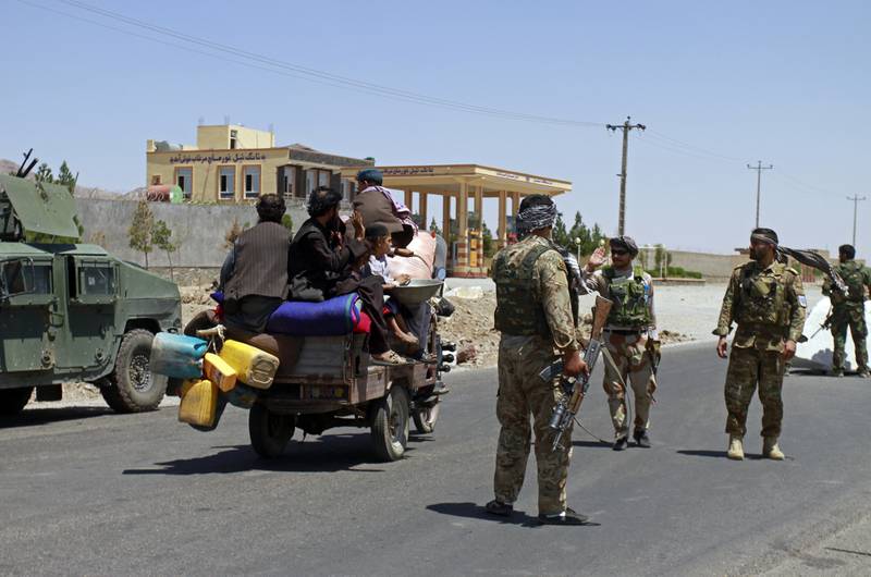 Civilians travel through the Herat after Afghan security forces regained control of parts of the city. AP