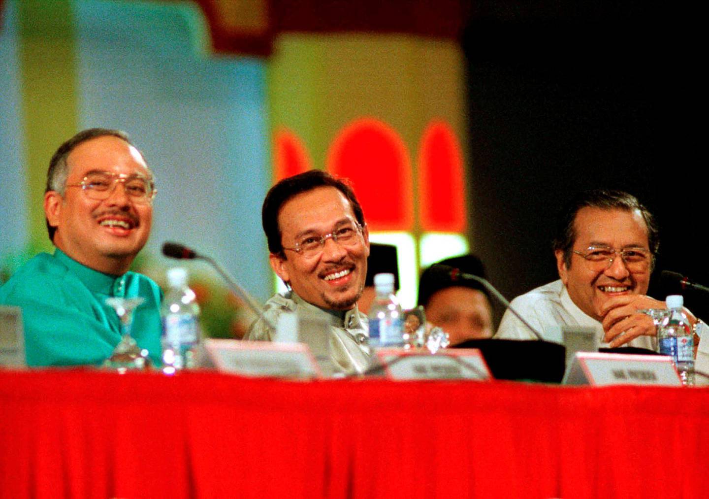 FILE PHOTO: Malaysia's Education Minister Najib Razak, Deputy Prime Minister Anwar Ibrahim and Prime Minister Mahathir Mohamad (L-R) laugh at a joke by one of the delegates during the United Malays National Organisation's (UMNO) annual general assembly in Kuala Lumpur, June 20, 1998. REUTERS/Stringer/File Photo