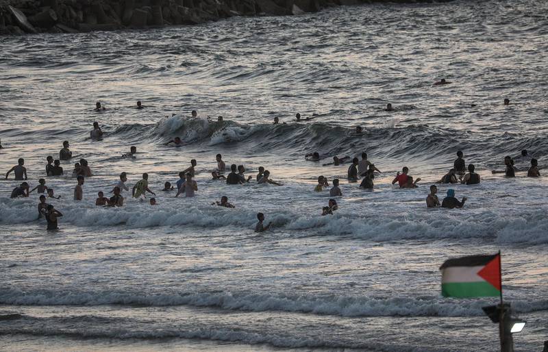 Palestinian refugees swim in the sea, in Gaza City, Gaza Strip, amid the ongoing pandemic caused by the novel coronavirus.  EPA