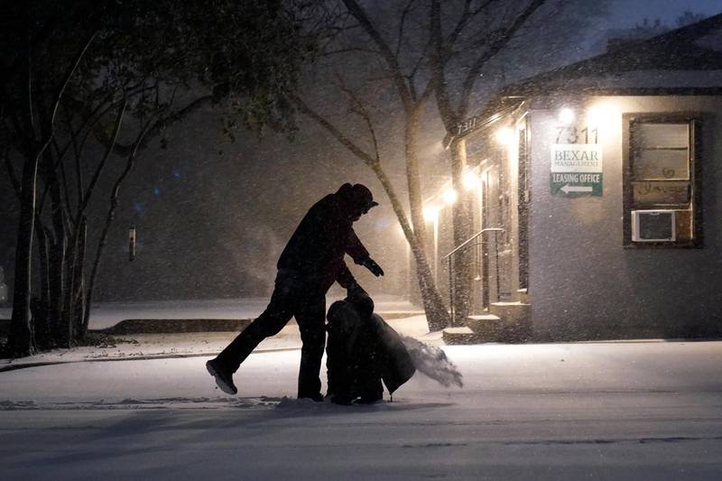 Two people play in the snow in San Antonio. AP