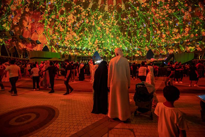 Visitors watch a light show at Al Wasl Plaza at Expo 2020 Dubai. Victor Besa / The National.