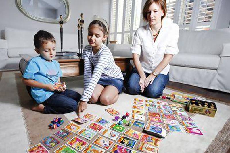 Maia, 7, right and Aiman, 3, with their mother Annabel Kantaria looking on show off their Moshi Monster collection in their home in Dubai. Sarah Dea /The National