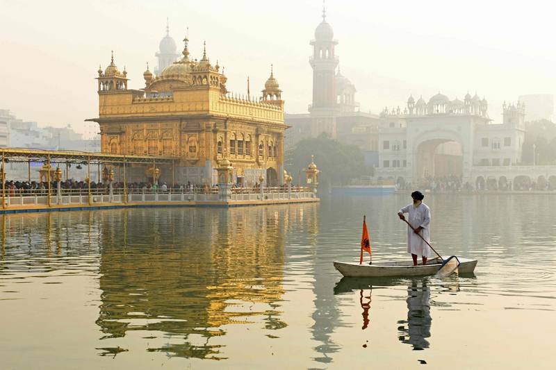 A volunteer cleans the holy sarovar or sacred pool at the Golden Temple.  AFP