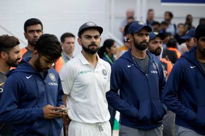 India captain Virat Kohli, center left, waits with his teammates for the trophy presentations to start after England won the fifth cricket test match and the five match series between England and India at the Oval cricket ground in London, Tuesday, Sept. 11, 2018. (AP Photo/Matt Dunham)