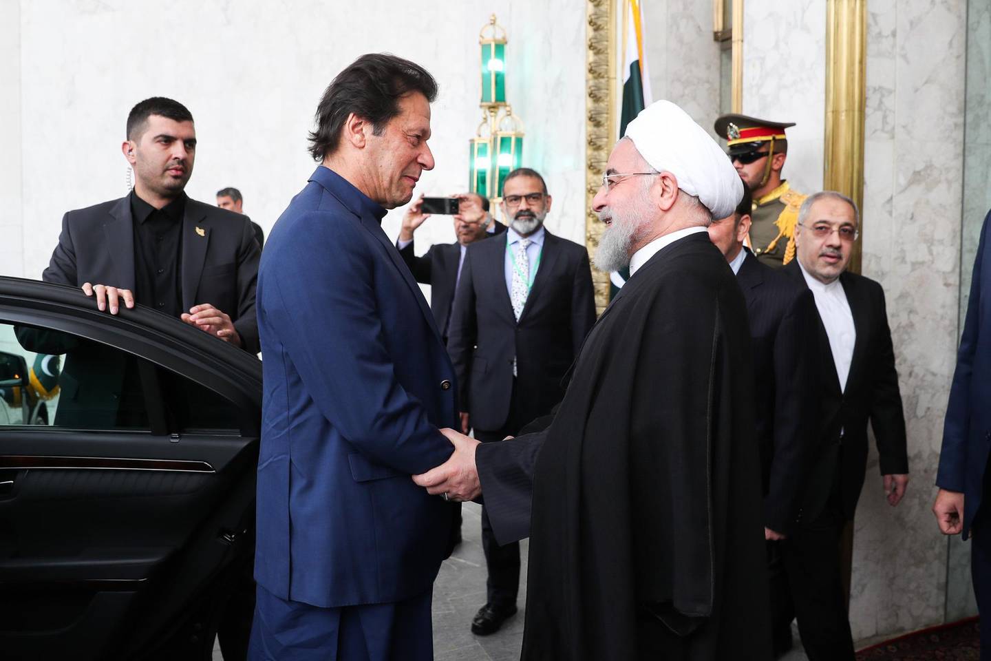 TEHRAN, IRAN - OCTOBER 09: (----EDITORIAL USE ONLY  MANDATORY CREDIT - "IRANIAN PRESIDENCY / HANDOUT" - NO MARKETING NO ADVERTISING CAMPAIGNS - DISTRIBUTED AS A SERVICE TO CLIENTS----) Iranian President Hassan Rouhani (R) welcomes Prime Minister of Pakistan Imran Khan (L) at Sa'dabad Palace Complex in Tehran, Iran on October 13, 2019. (Photo by IRANIAN PRESIDENCY / HANDOUT/Anadolu Agency via Getty Images)