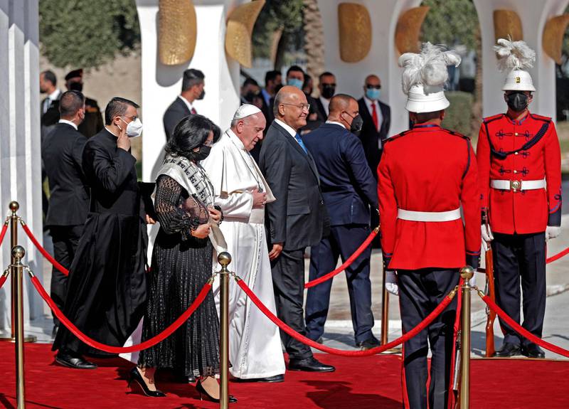 Iraq's President Barham Saleh and his wife Sarbagh escort Pope Francis during the farewell ceremony for the pontiff at the Iraqi capital's Baghdad International Airport. AFP