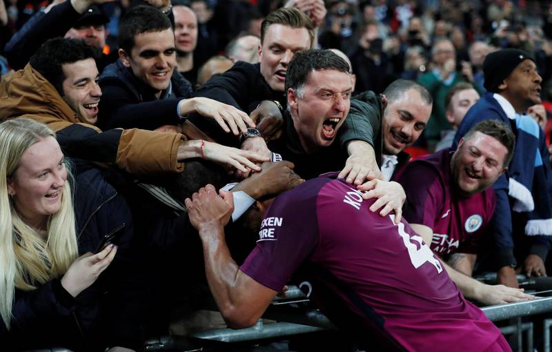 Manchester City's Vincent Kompany celebrates with fans after the match. David Klein / Reuters