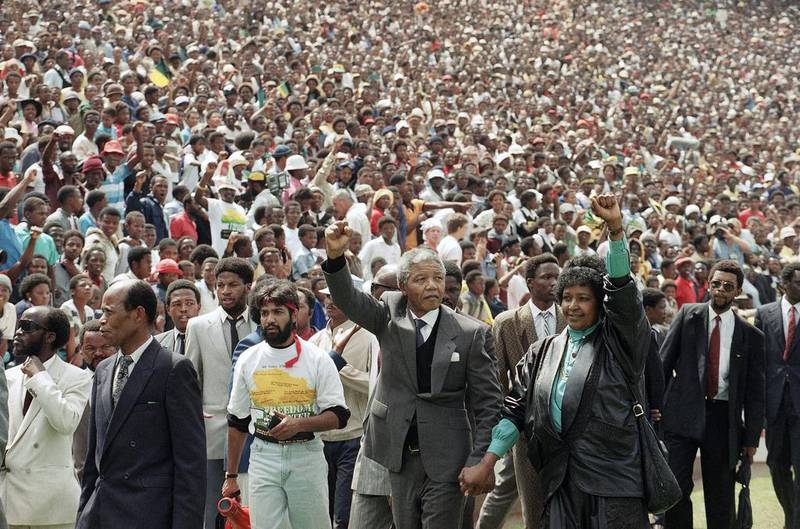 February 13, 1990: Nelson Mandela and Winnie Mandela give salutes as they enter Soccer City stadium in the Soweto. Udo Weitz / AP Photo