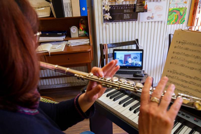 A music school teacher holds a one-to-one online flute lesson in her home in Nagykanizsa, southwestern Hungary, on March 17, 2020. EPA