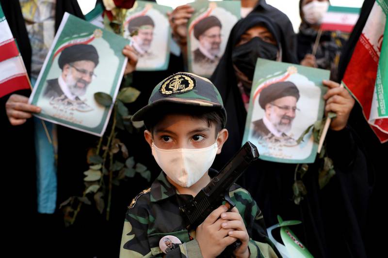 An Iranian child holds a toy gun at a celebration to mark the victory of Ebrahim Raisi in the presidential elections. The vote appeared to see the lowest turnout in the Islamic Republic’s history. AP Photo