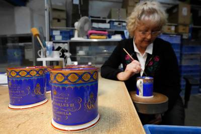 A potter works on chinaware produced for the coronation at a factory in Stoke-on-Trent. AFP
