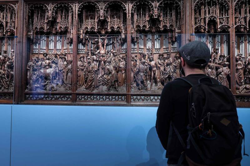 A man looks at a restored original altrapiece of Saint-George (1493) by  Flemish Northern renaissance sculptor Jan Borman at the Art & History Museum in Brussels on April 23, 2021.  / AFP / Kenzo TRIBOUILLARD

