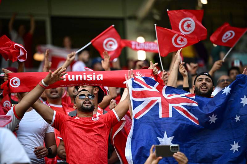 Australia and Tunisia supporters cheer their teams at Al Janoub Stadium. AFP