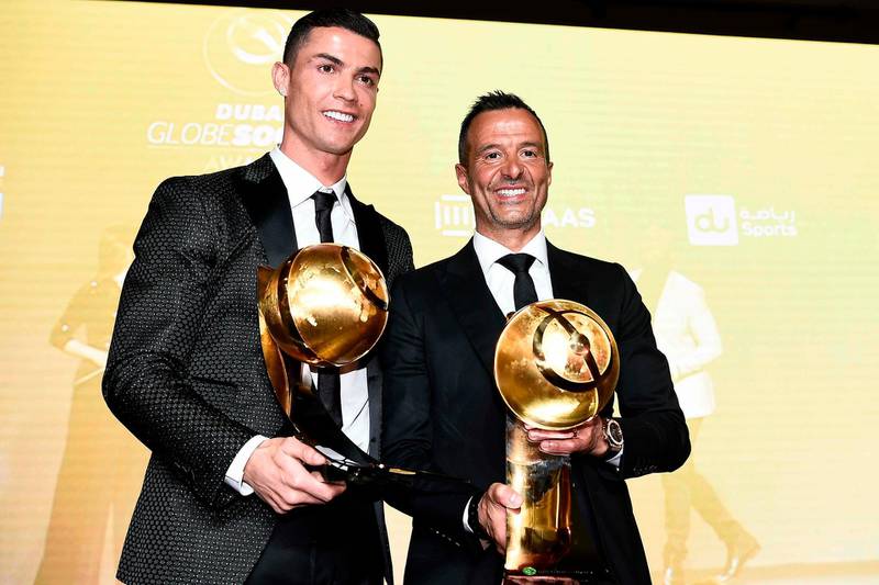 Juventus' Portuguese forward Cristiano Ronaldo (L), holding his "Best Player of the Year 2018 Award" and Portuguese football agent Jorge Mendes, holding his "Best Agent of the Year 2018 Award" pose during the 10th edition of the Dubai Globe Soccer Awards  in Dubai. AFP
