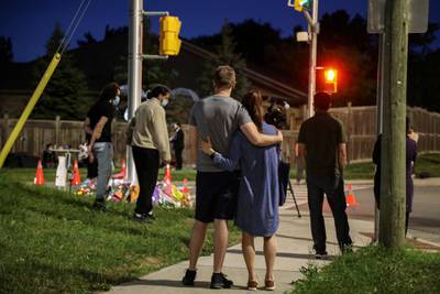 Visitors gather at a makeshift memorial to members of a Muslim family who were killed in a hit-and-run attack in London, Ontario, Canada. Police say the incident was a hate crime. Reuters