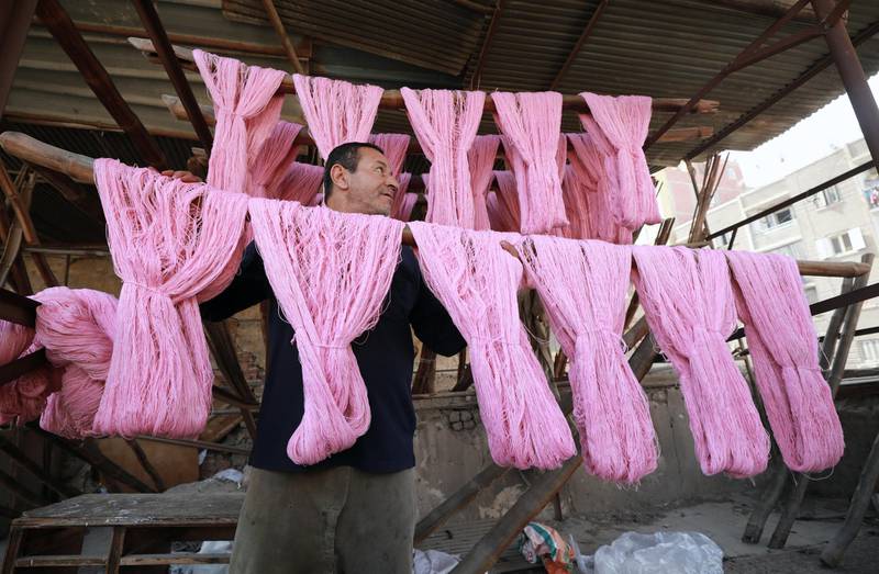 Once coloured, the cotton is rinsed and then hung outside to dry. EPA / Khaled Elfiqi