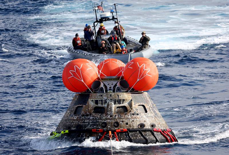 AT SEA, PACIFIC OCEAN - DECEMBER 11: NASA's Orion Capsule is drawn to the well deck of the U. S. S.  Portland after it splashed down following a successful uncrewed Artemis I Moon Mission on December 11, 2022 seen from aboard the U. S. S.  Portland in the Pacific Ocean off the coast of Baja California, Mexico.  A 26-day mission took the Orion spacecraft to the moon and back which completed a historic test flight that coincided with the 50th anniversary of the landing of Apollo 17 on the moon, the last time that NASA astronauts walked there.  Mario Tama / Pool via REUTERS     TPX IMAGES OF THE DAY