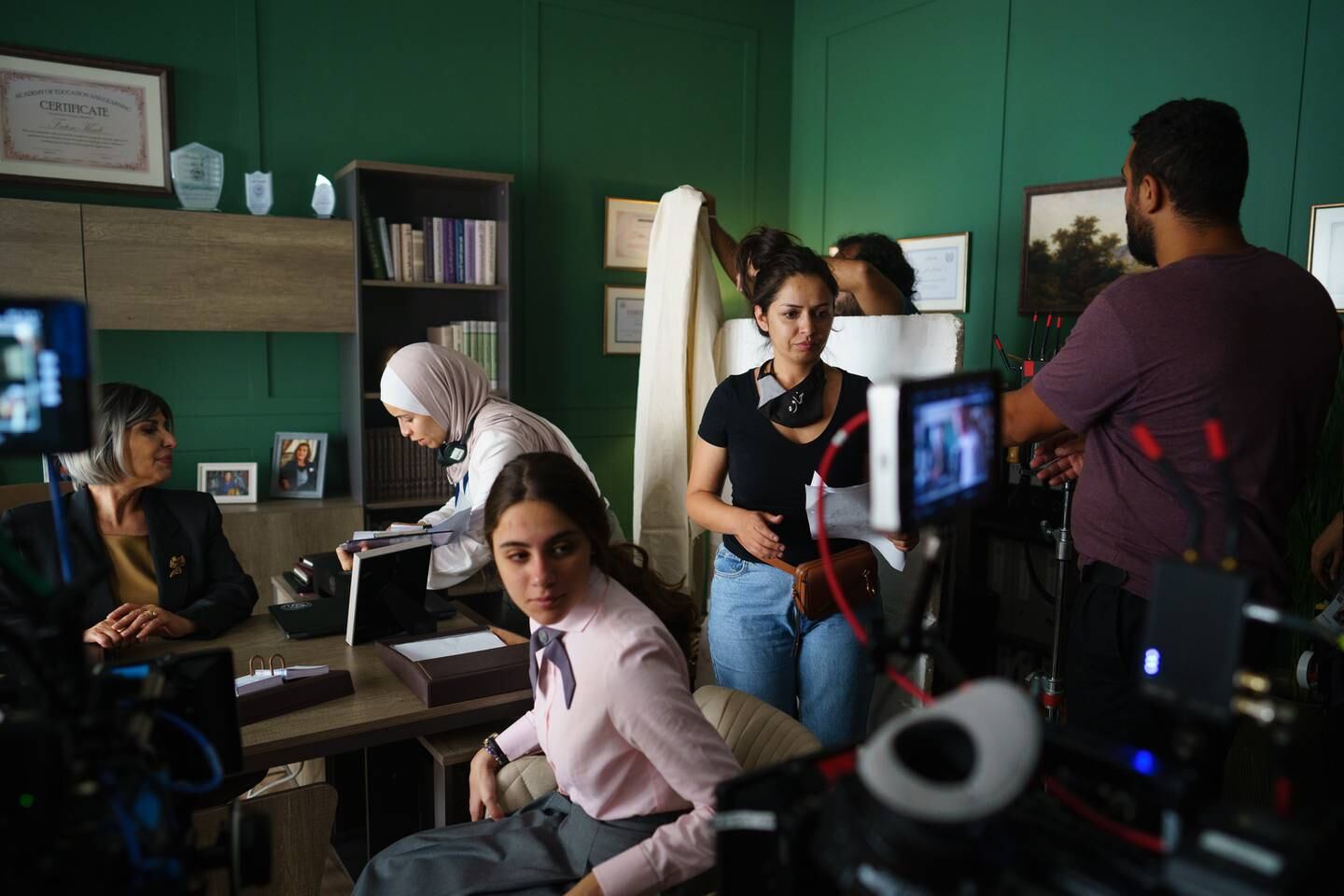 Director and co-creator Tima Shomali, second right, behind the scenes of 'Al Rawabi School for Girls'. Netflix