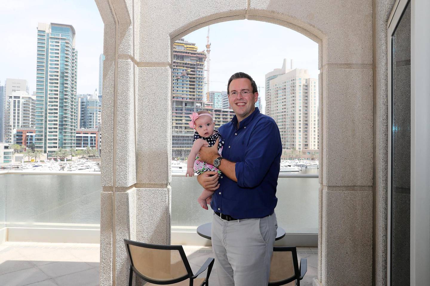 DUBAI, UNITED ARAB EMIRATES , July 20 – 2020 :- Andrew Cummings with his daughter Isabella Cummings ( around 5 months old) at his new villa in the Beauport, Marina Promenade, Dubai Marina in Dubai. He shifted from an apartment to a villa during the pandemic.  (Pawan Singh / The National) For Business. Story by Deepthi Nair