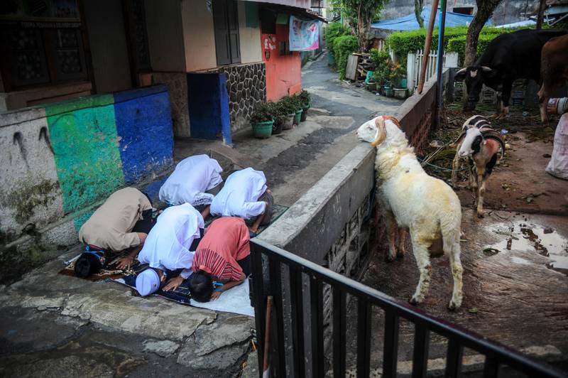 Indonesian Muslims offer Eid Al Adha prayers on the street amid a surge of Covid-19 cases in Bandung, West Java province, Indonesia.