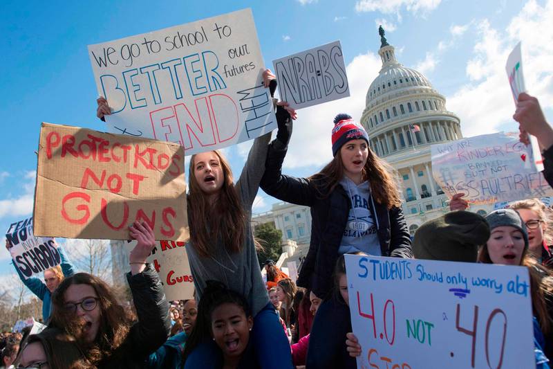 TOPSHOT - Students participate in a rally with other students from DC, Maryland and Virginia in their Solidarity Walk-Out to urge Republican leaders in Congress "to allow votes on gun violence prevention legislation." on Capitol Hill in Washington, DC, March 14, 2018.
Students across the US walked out of classes on March 14, in a nationwide call for action against gun violence following the shooting deaths last month at a Florida high school. The nationwide protest is being held one month to the day after Nikolas Cruz, a troubled 19-year-old former student at Stoneman Douglas, unleashed a hail of gunfire on his former classmates. / AFP PHOTO / JIM WATSON