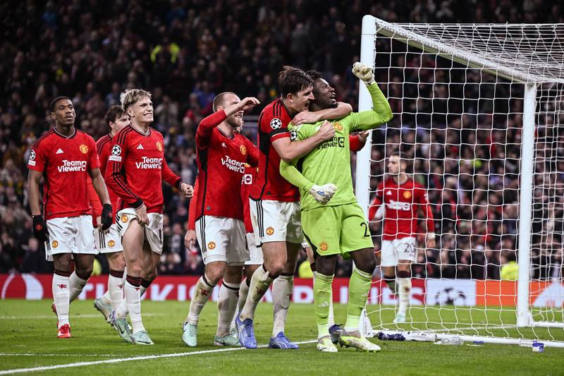 Manchester United's Cameroonian goalkeeper Andre Onana celebrates with teammates after saving a penalty kick at the end of the UEFA Champions League Group A football match between Manchester United and FC Copenhagen. AFP