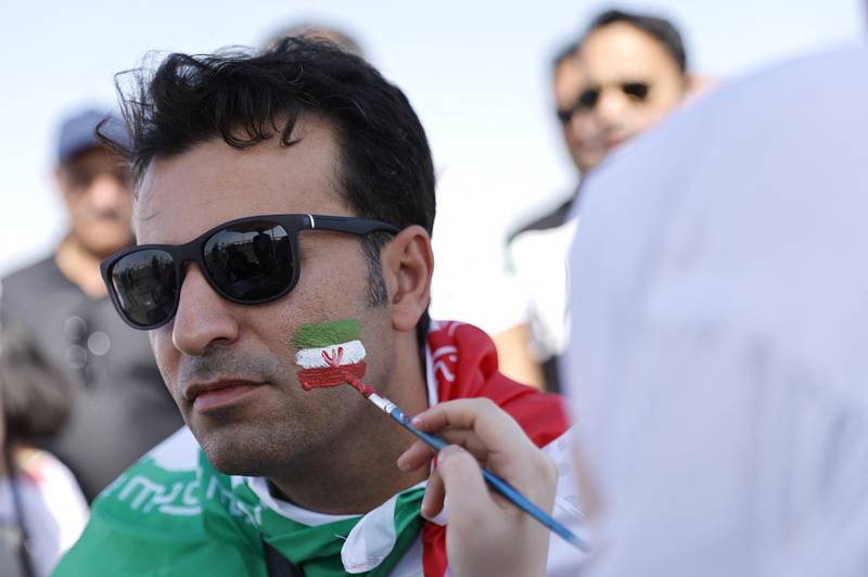 An Iran fan has his face painted ahead of the clash with Wales. Reuters
