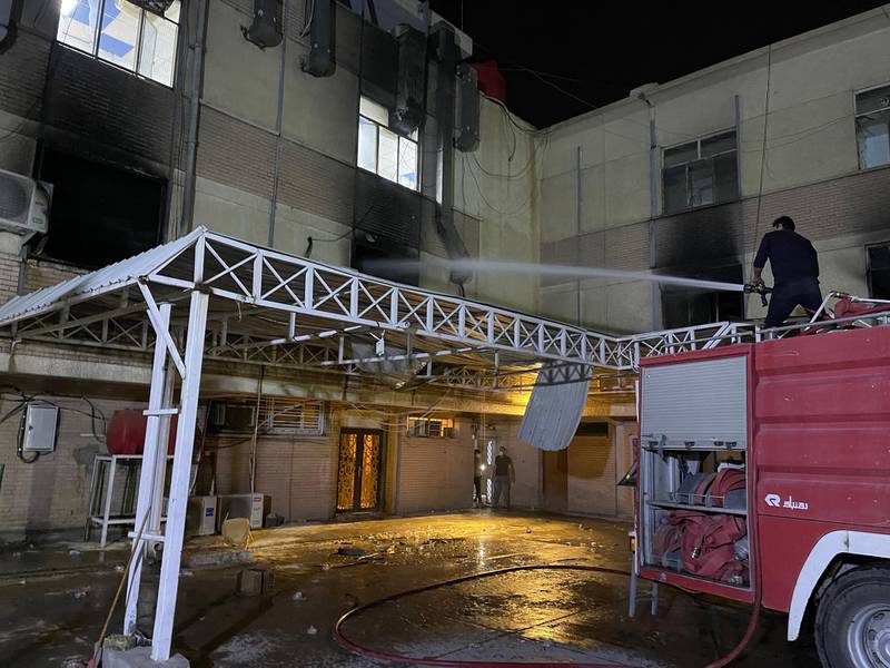 Firefighters extinguish a fire that broke out at Ibn Al Khateeb hospital, south of Baghdad, EPA