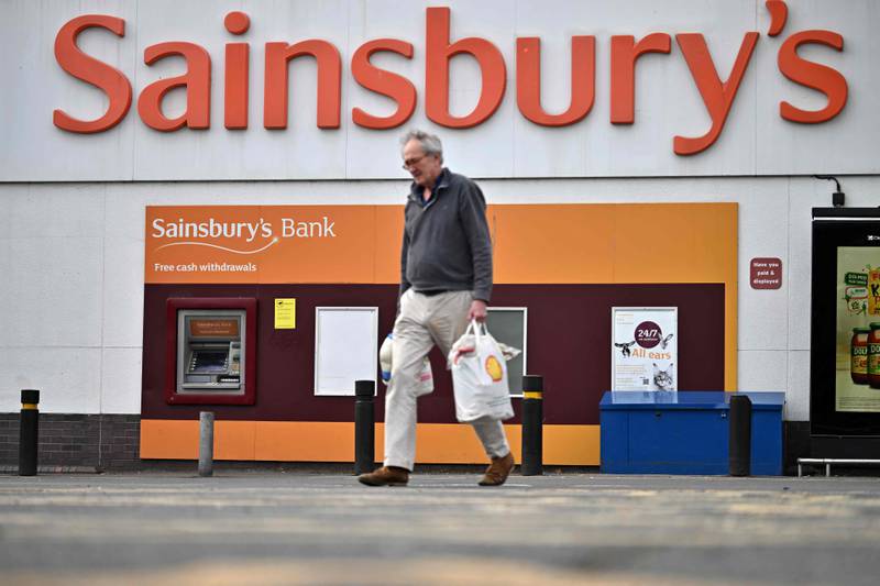 A shopper walks away from a Sainsbury's supermarket store in Tonbridge, south-east of London on April 28, 2022.  - Sainsbury's showed pre-tax profits for the 12 months to March 5, 2022 rose to £854 million as the supermarket was advantaged by the pandemic.  (Photo by Ben Stansall  /  AFP)