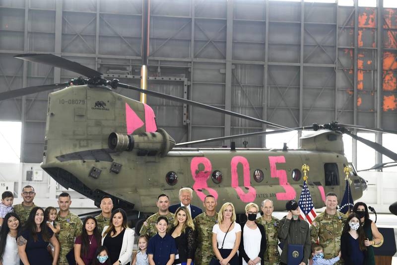 US President Donald Trump poses with pilots and crew members of the California Army National Guard and their families at Sacramento McClellan Airport in McClellan Park, California.  AFP