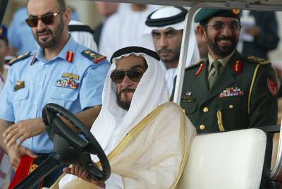 The United Arab Emirates' President Sheikh Zayed bin Sultan al-Nahyan (C) and Emirati army Cheif of Staff Sheikh Mohammed bin Zayed al-Nahyan (L) attend a military show on the second day of the International Defense Exhibition (IDEX 2003) in Abu Dhabi 17 March 2003. A total of 825 arms manufacturers from 46 countries, notably the United States, Britain, France and Russia are taking part in the Middle East's biggest arms fair. AFP PHOTO/Rabih MOGHRABI (Photo by RABIH MOGHRABI / AFP)