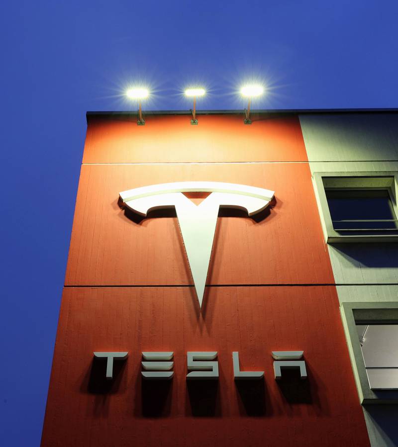 FILE PHOTO: A logo of car manufacturer Tesla is seen at a branch office, amid the coronavirus disease (COVID-19) outbreak, in Bern, Switzerland December 10, 2020. Picture taken December 10, 2020. REUTERS/Arnd Wiegmann/File Photo