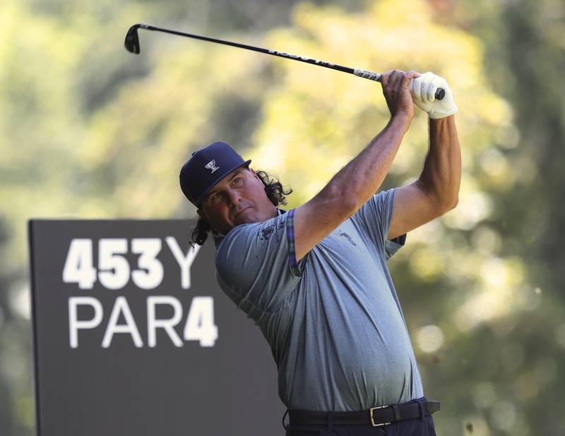 Pat Perez watches his tee shot on the fourth hole. AP 