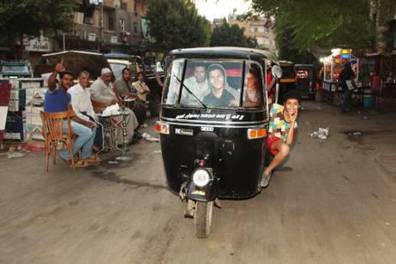 Boys drive a three-wheeled motor rickshaw, or “tuk tuk” in the blighted Cairo suburb of Imbaba on November 5, 2010. Victoria Hazou for the National