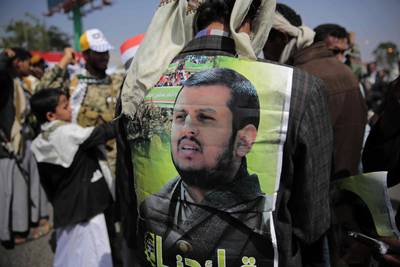 A Supporter of Houthi Shiites displays a poster of Abdel-Malek al-Houthi, the leader of Yemen's Shiite rebels, on his jacket during a rally to mark the third anniversary of the Houthis' takeover of the Yemeni capital, in Sanaa, Yemen, Thursday, Sept. 21, 2017. Al-Houthi, lashed out in a defiant speech broadcast Wednesday, the eve of the anniversary of the day his forces stormed into Sanaa. Al-Houthi accused the U.S., Saudi Arabia and the UAE of seeking to divide Yemen. (AP Photo/Hani Mohammed)