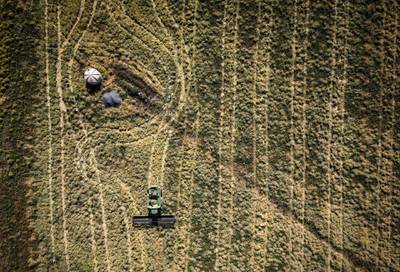 A farmer harvests grass seeds in a field in this aerial photograph taken over a farm near Gunnedah, New South Wales, Australia, on last month. Australia’s call for a probe into the origins of the virus have further strained ties. Beijing has labeled calls for the investigation "politically motivated," warning of a potential consumer boycott of Australian products. Bloomberg