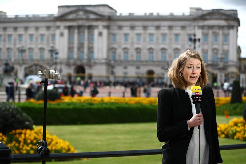 A member of the media reports outside Buckingham Palace. Reuters
