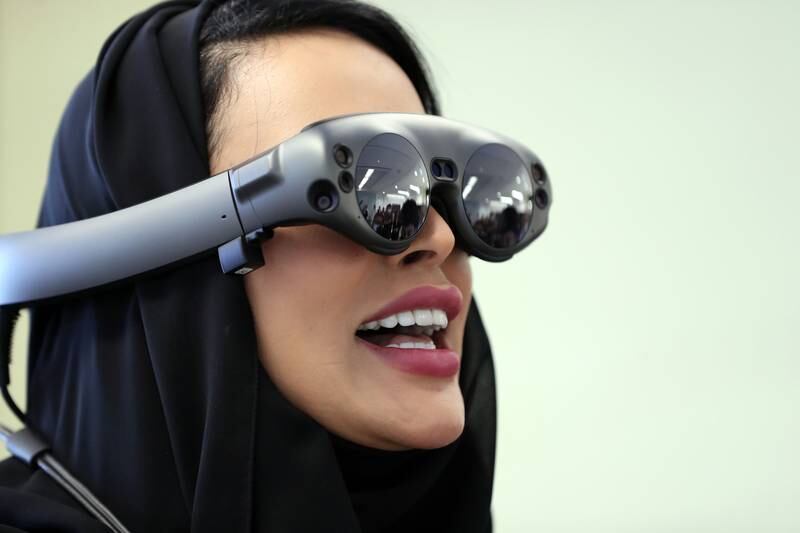 Nadia Al Thaibani from the Abu Dhabi Digital Authority trying out an augmented reality experience of Abu Dhabi through 3D glasses at the launch of Oracle's new innovation centre on Reem Island on Wednesday. Chris Whiteoak / The National