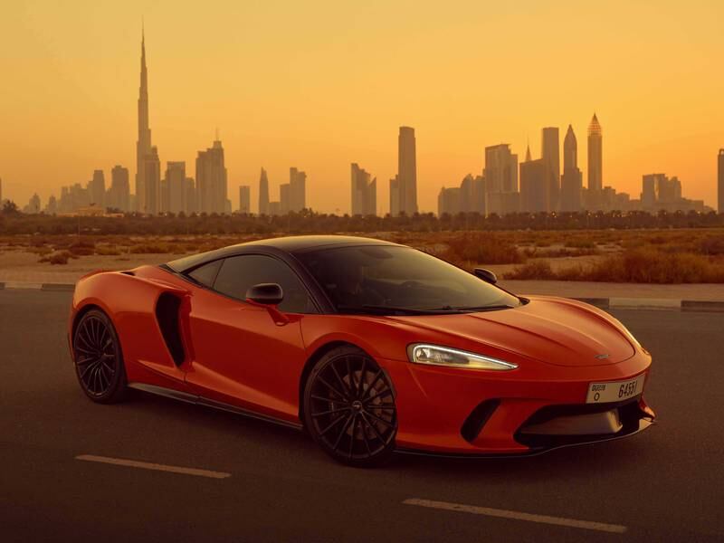 A GT at dusk, before the Dubai skyline.