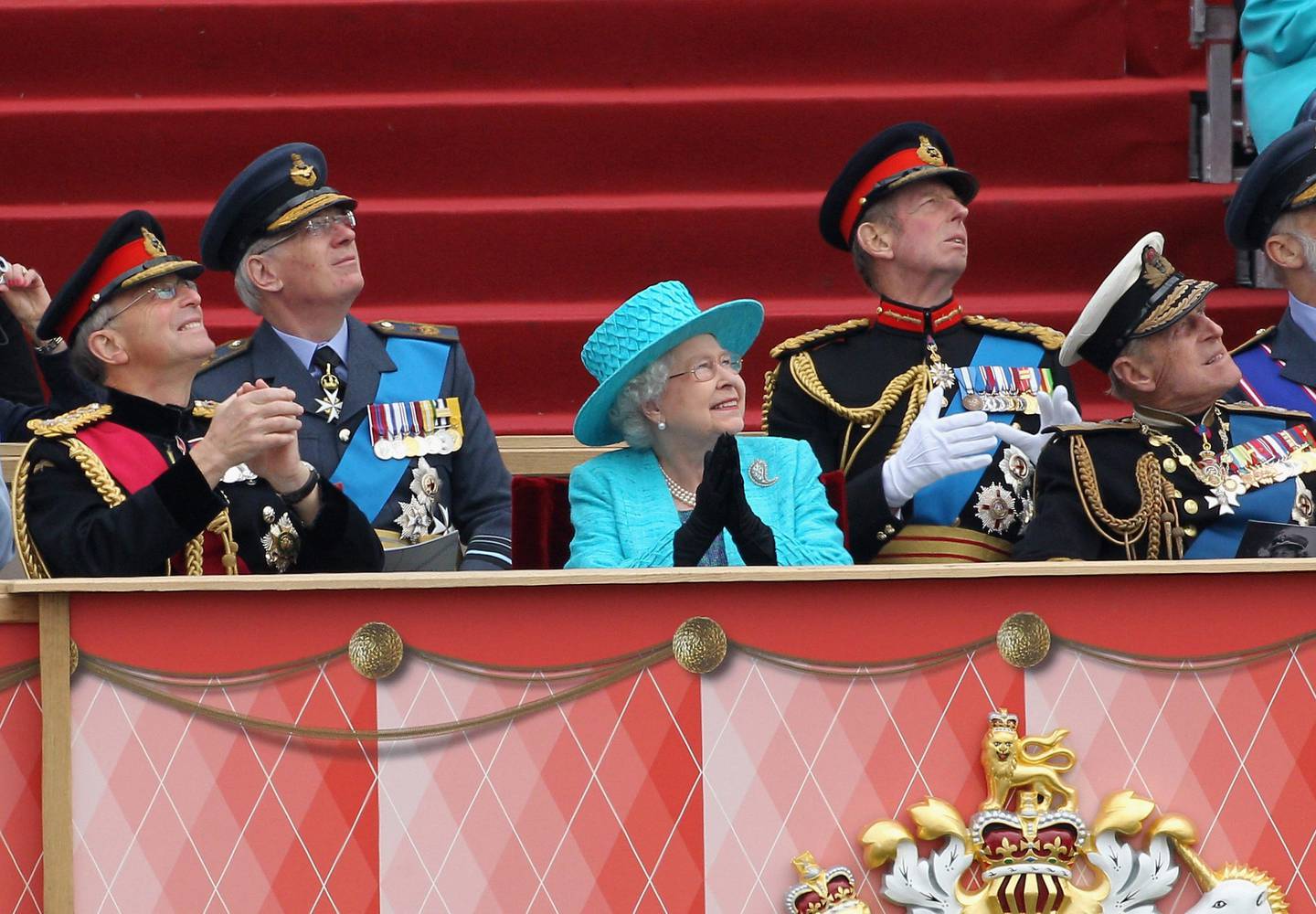 Gen Sir David Richards, left, former chief of the defence staff, Queen Elizabeth and the Duke of Edinburgh watching a flypast during an armed forces parade at Windsor Castle in 2012. PA