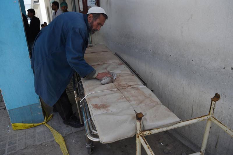 An Afghan member of medical staff cleans a stretcher following a suicide bombing attack at the Isteqlal Hospital in Kabul on April 22, 2018.
A suicide bomber killed at least 31 people and wounded dozens outside a voter registration centre in the Afghan capital Kabul on April 22, the health ministry said, in the latest attack on election preparations. / AFP PHOTO / WAKIL KOHSAR
