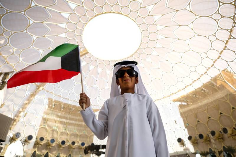 A child holds the Kuwaiti flag during Kuwait's National Day ceremony at Al Wasl Plaza, Expo 2020 Dubai. Photo by Christopher Edralin / Expo 2020 Dubai