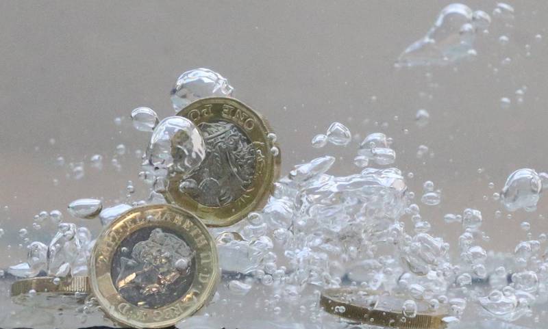 FILE PHOTO: UK pound coins plunge into water in this illustration picture, October 26, 2017. REUTERS/Dado Ruvic/Illustration/File Photo