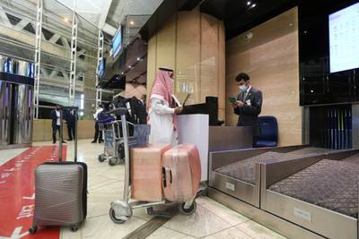 A traveller checks in at the King Khalid International Airport in Riyadh after Saudi authorities lifted a lengthy travel ban to curb coronavirus infections. Reuters
